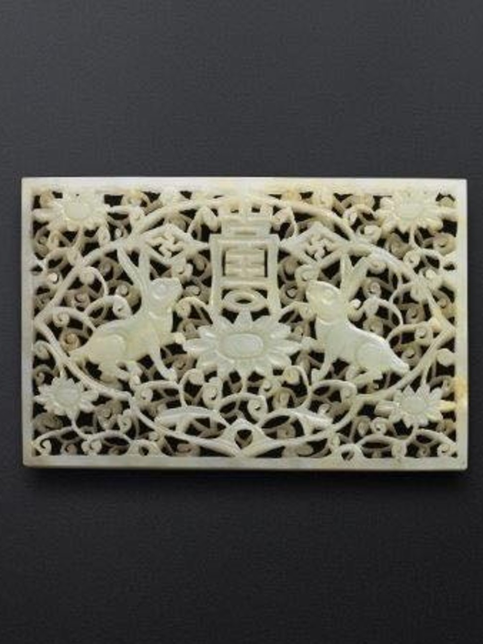 A white jade belt plaque, featuring two rabbits below two swastikas flanking the Chinese character ‘Shou’ – a combination that was a birthday greeting reserved for emperors – which was excavated from Emperor Wanli’s Dingling mausoleum on the outskirts of Beijing.