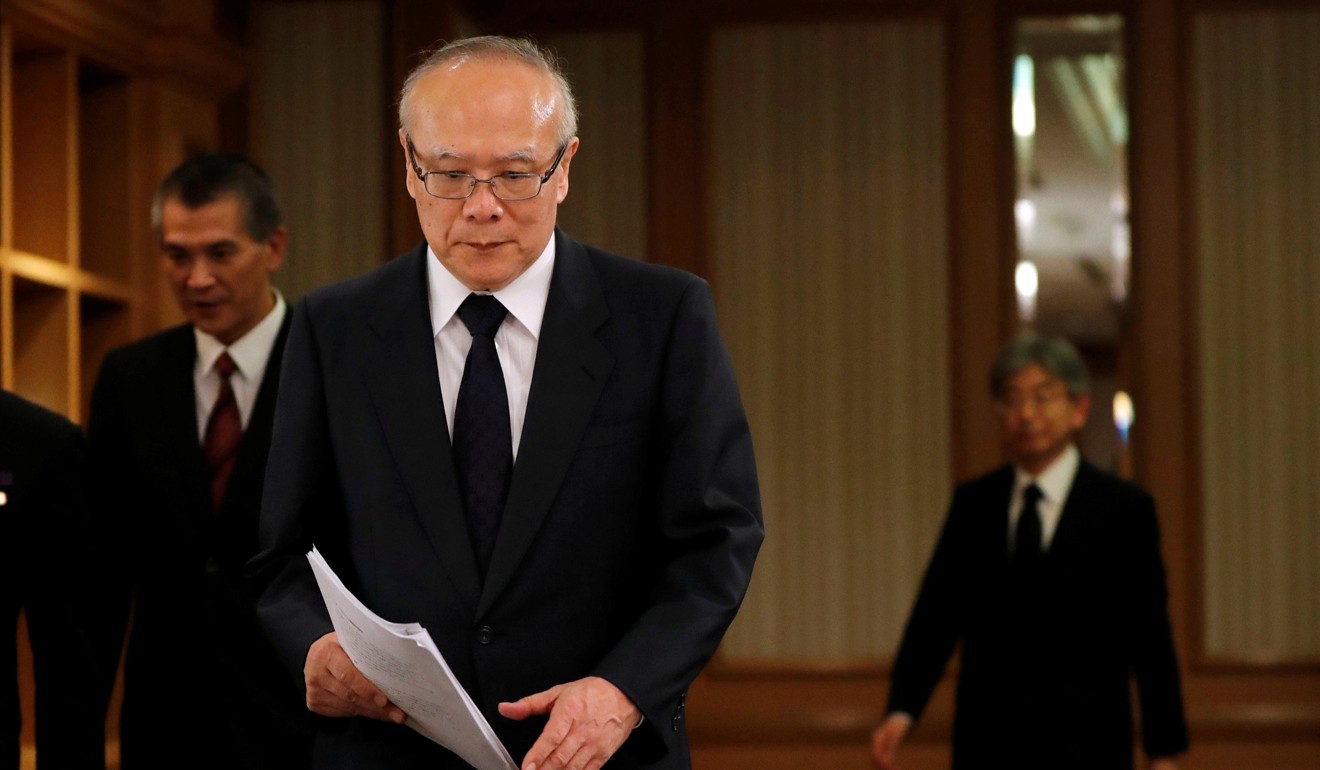 Yukioka (foreground) and Miyazawa (right) at the news conference on Tuesday. Miyazawa said he would discuss with the government the possibility of belatedly accepting rejected applicants if identified. Photo: Reuters