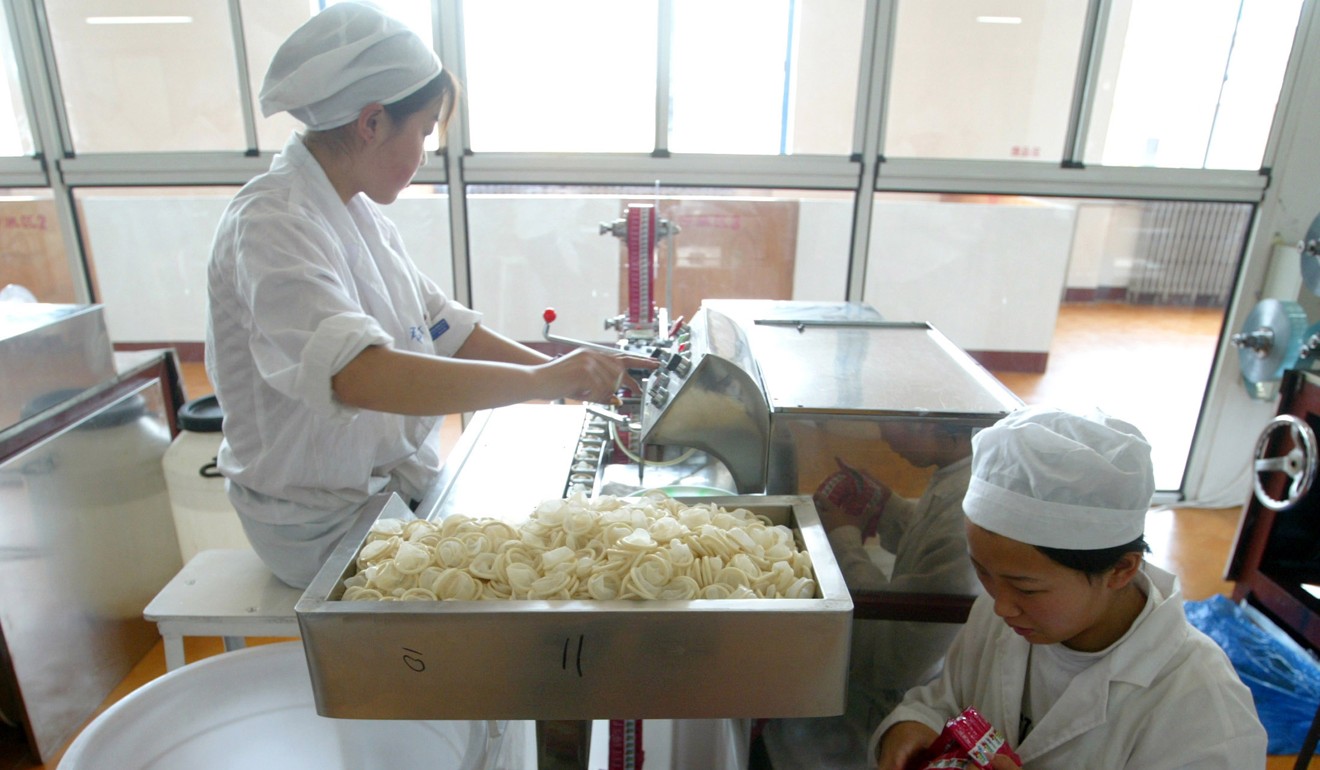 Chinese workers pack condoms at a factory in Xiong County, Hebei province, in 2004. Photo: Reuters