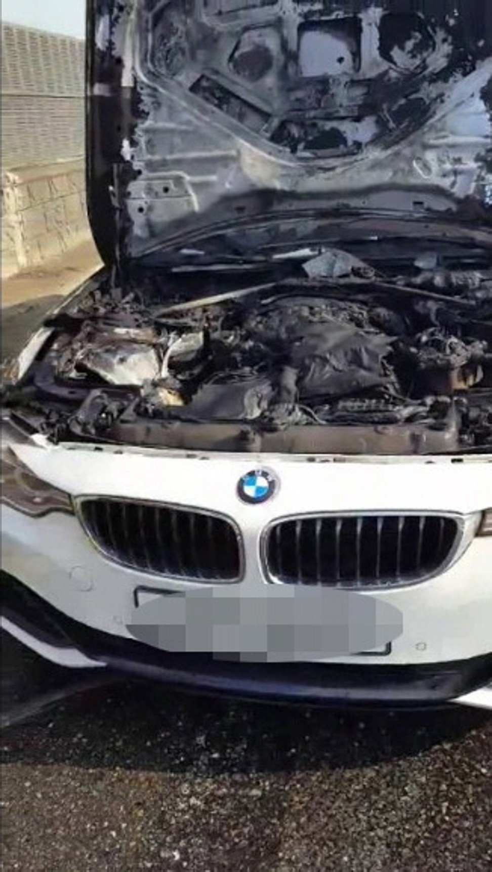 The burnt wreck of a BMW vehicle that caught fire on a highway in Incheon. Photo: EPA