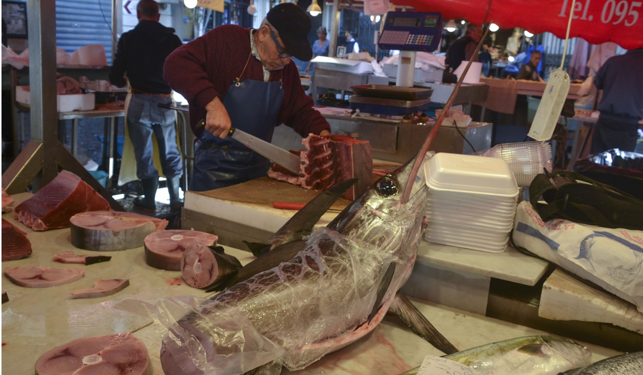 A huge fish being sliced up for sale at the Catania market. Photo: Chris Dwyer