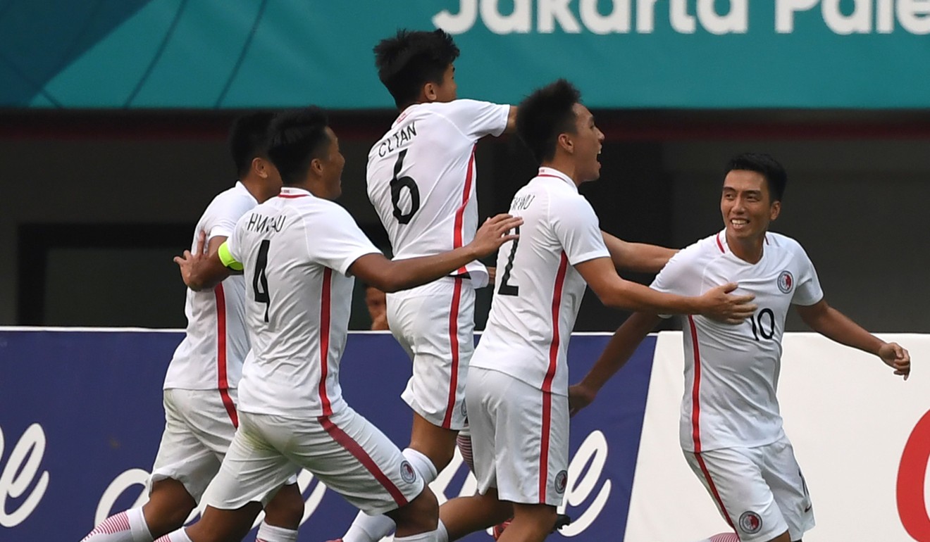 Hong Kong’s Lam Ka-wai (right) is mobbed by teammates after scoring the equaliser against Palestine. Photo: AFP