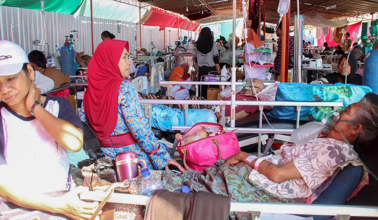 Patients and their family members at a makeshift hospital ward in Mataram. Photo: AFP