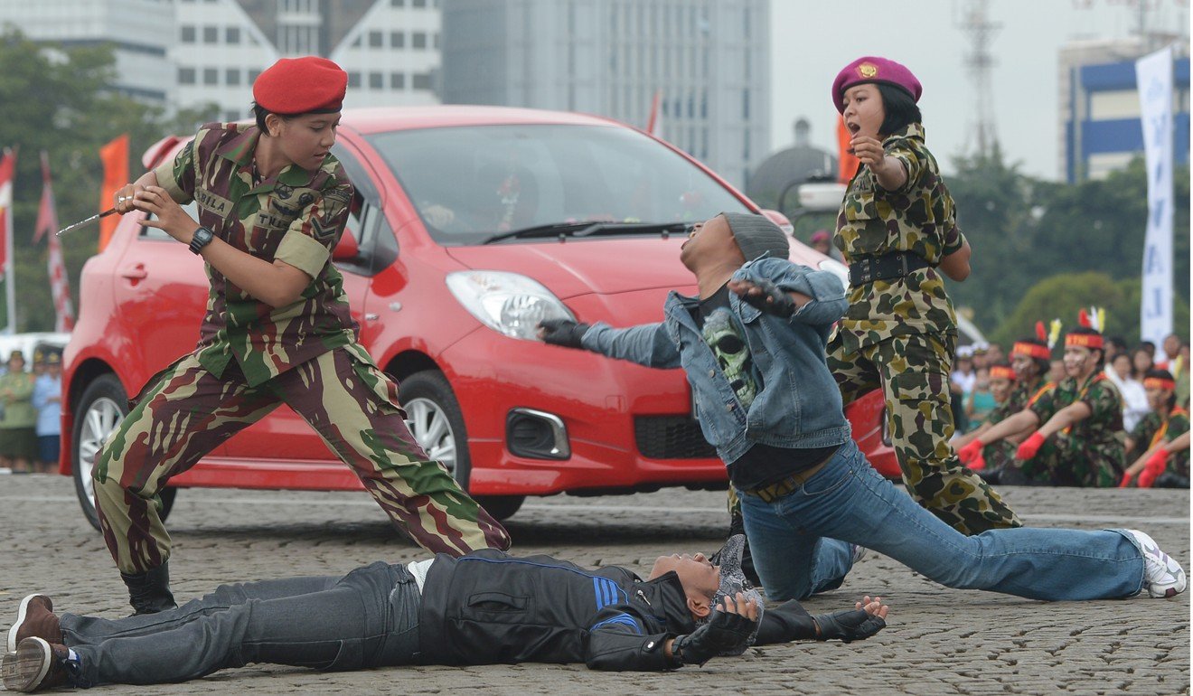 A female member of the Indonesian Special Army Forces (left) and one from the marines (right) show their martial arts skills as they mark Kartini Day in Jakarta in 2013. The event commemorates the birth of Raden Ajeng Kartini, an Indonesian heroine born in 1879, a pioneer in the emancipation of Indonesian women. Photo: AFP