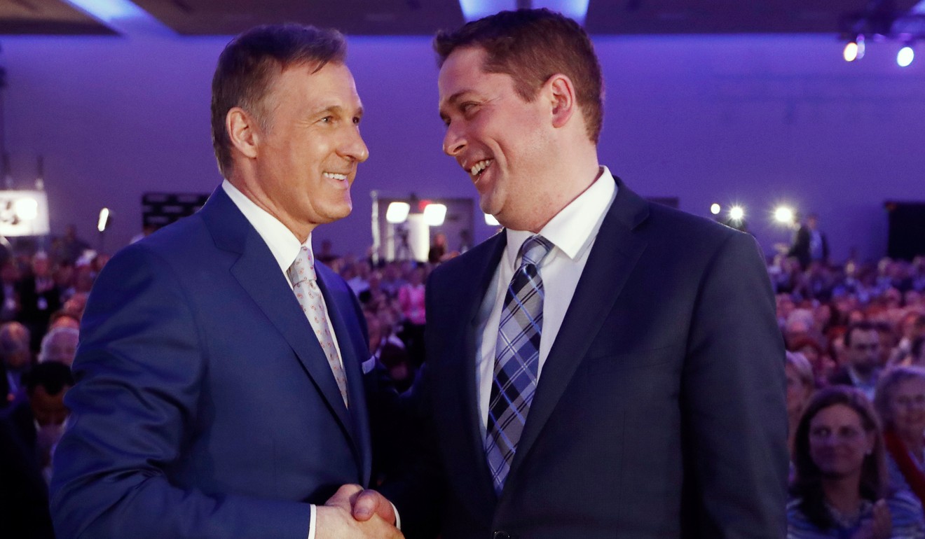Maxime Bernier (left) speaks with Andrew Scheer after the first results are announced during the Conservative Party of Canada leadership convention in Toronto in May 27, 2017. Photo: Reuters