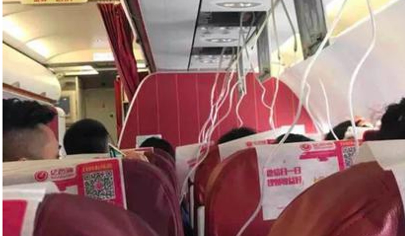 On board the Capital Airlines flight from Kunming to Hangzhou, shortly after oxygen masks dropped due to a sudden loss of cabin pressure. Photo: Sina.com.cn