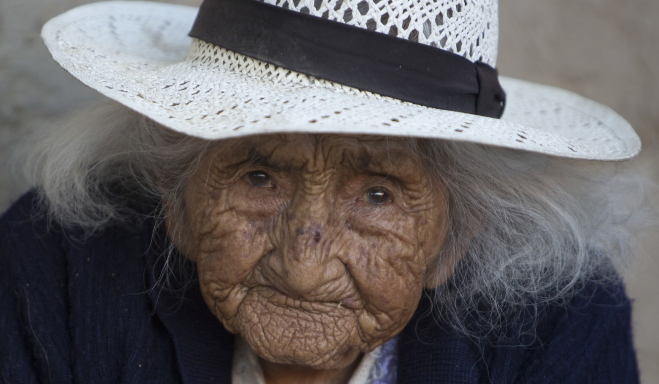 In this August 23, 2018 photo, 117-year-old Julia Flores Colque eyes the camera while sitting outside her home in Sacaba, Bolivia. Photo: AP