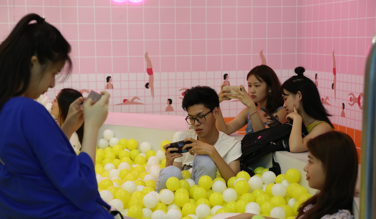 Visitors to The Egg House in Shanghai sit in a pool of fake eggs. Photo: Rachel Cheung