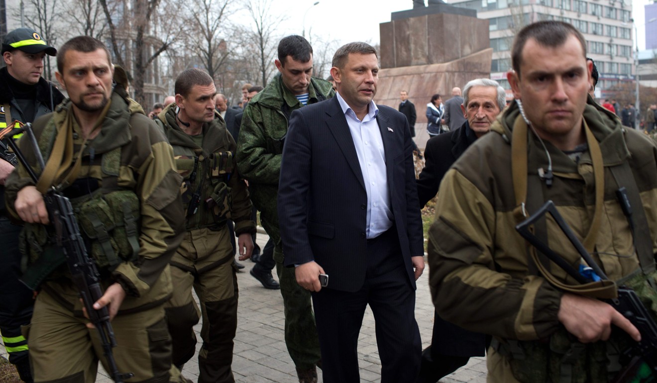 Alexander Zakharchenko (C) is escorted by armed men in Donetsk. File photo: AFP