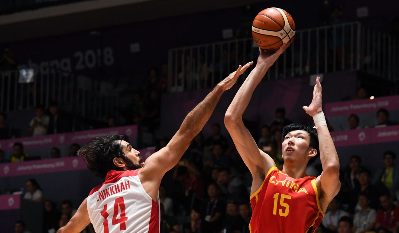 Iran's Mohammadsamad Nikkhahbahrami (14) tries to block China's Zhou Qi during the men's gold medal basketball match. Photo: AFP