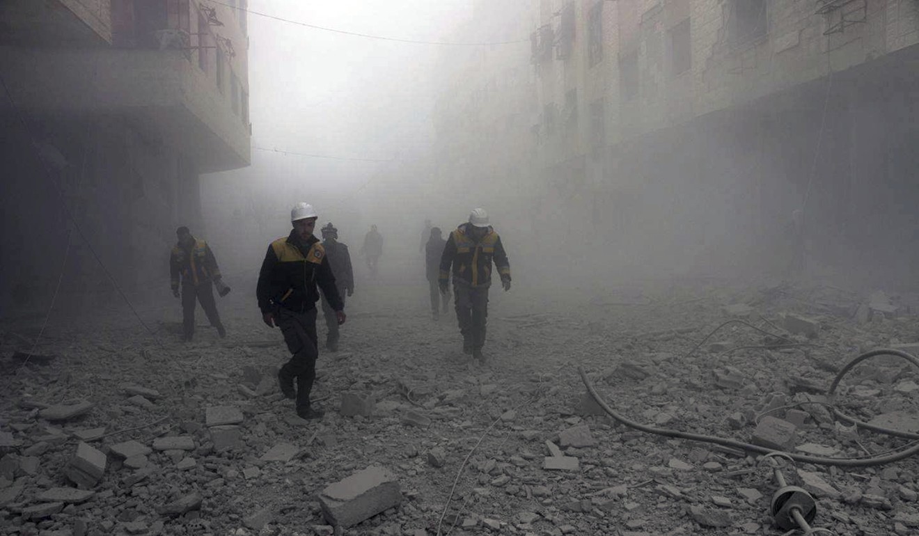 Members of the so-called White Helmets said to be searching for survivors after an airstrike. Photo: AP