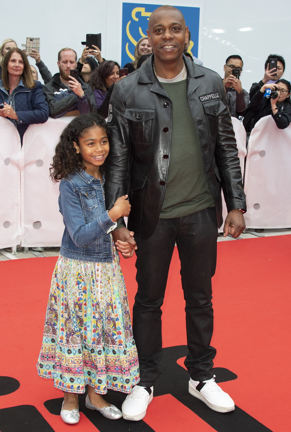 Cast member Dave Chappelle and his daughter Sanaa take to the red carpet. Photo: EPA