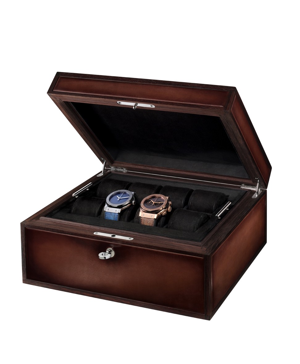 Berluti. This patinated Venezia leather watch box from Berluti is designed to hold eight watches. There is also a full Scritto version, and a full alligator version at a higher price, HK$68,200