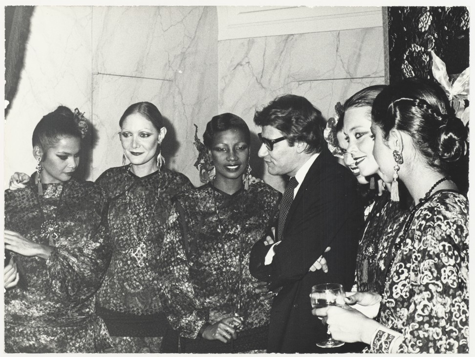 Saint Laurent surrounded by models at the launch of the Asian-inspired Opium fragrance in Paris, in 1977. Photo: Courtesy of Musee Yves Saint Laurent