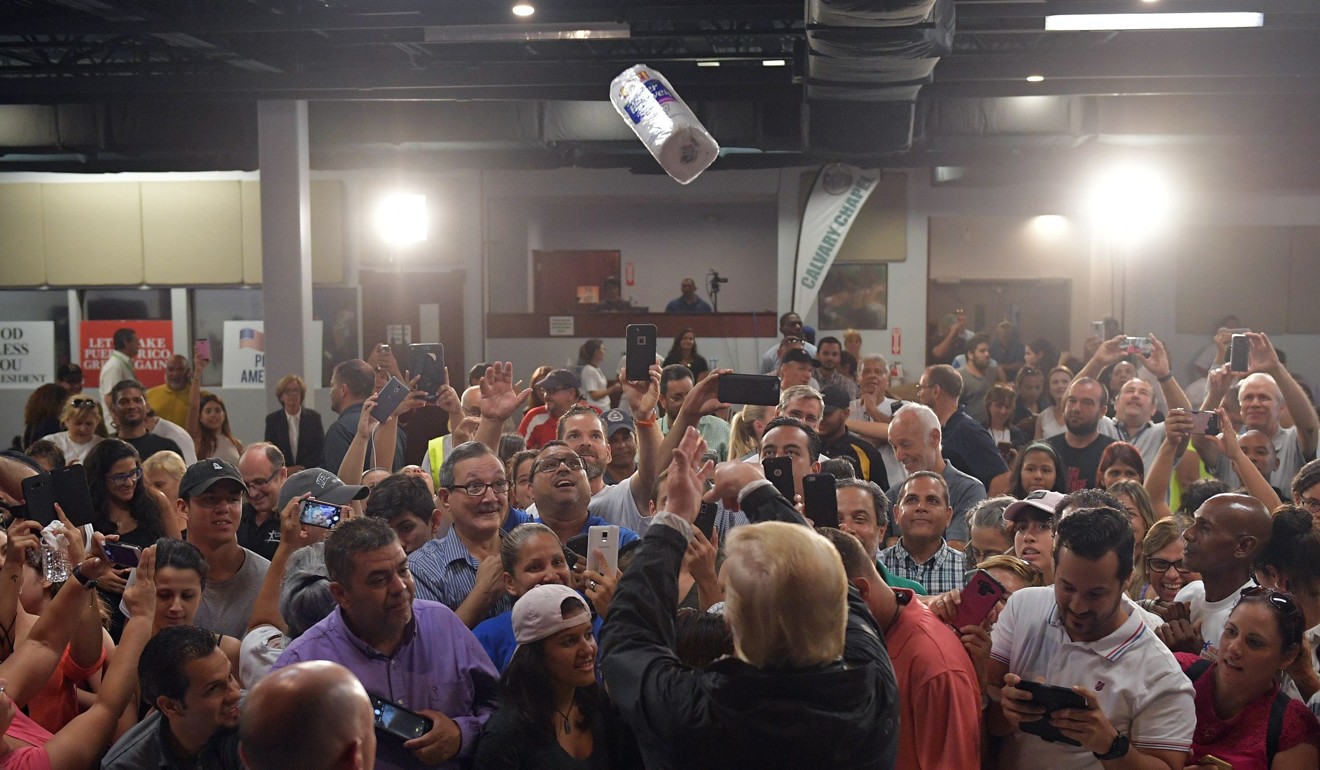 Trump throws a paper towel roll in the air at the Cavalry Chapel in Guaynabo, Puerto Rico on September 13, 2018. Photo: AFP