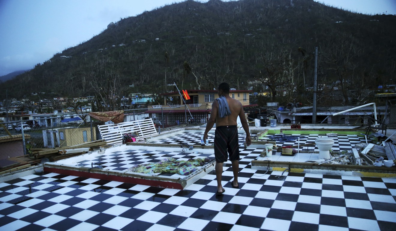 A September 2017 photo of Nestor Serrano walking on the upstairs floor of his home after the roof and walls were blown off by Hurricane Maria, in Yabucoa, Puerto Rico. Photo: AP