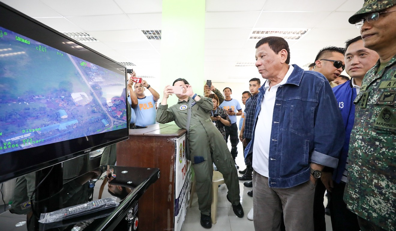 Philippine President Rodrigo Duterte watching aerial video of the damage done by Typhoon Mangkhut during a meeting with cabinet officials in Tuguegarao, Cagayan province on September 16, 2018. Photo: EPA