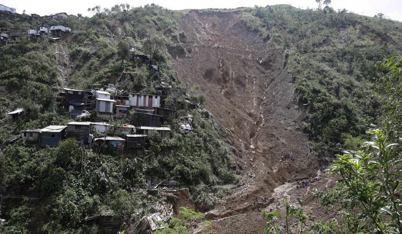 Houses perched near a landslide believed to have buried a number of people in Itogon. Photo: AP