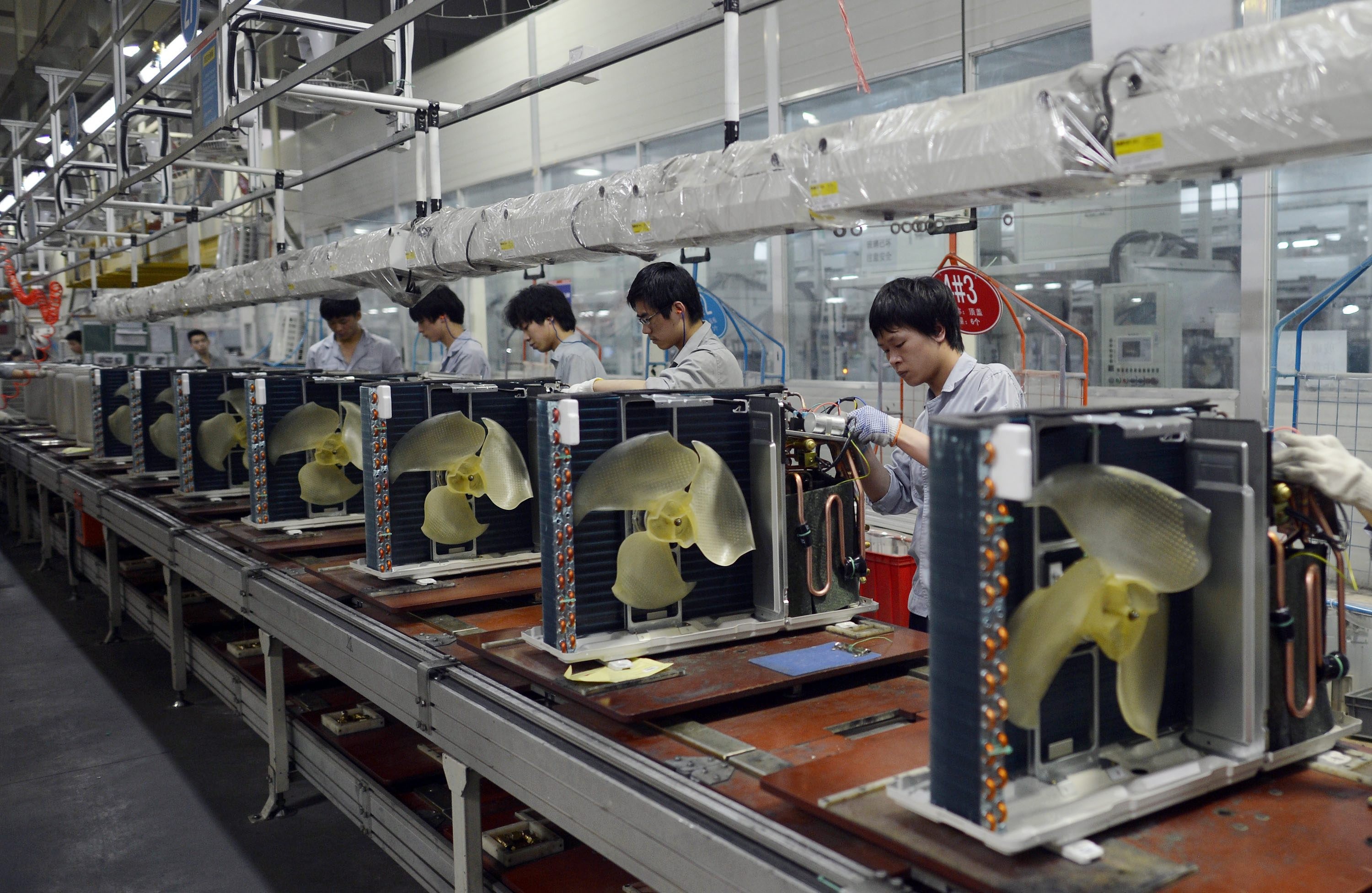Workers assemble air conditioners at a Gree Electric Appliances factory in Wuhan, China. China is already the world’s top producer of air conditioners and is expected to be a key player in the installation of 1 billion more globally over the next decade. Photo: EPA