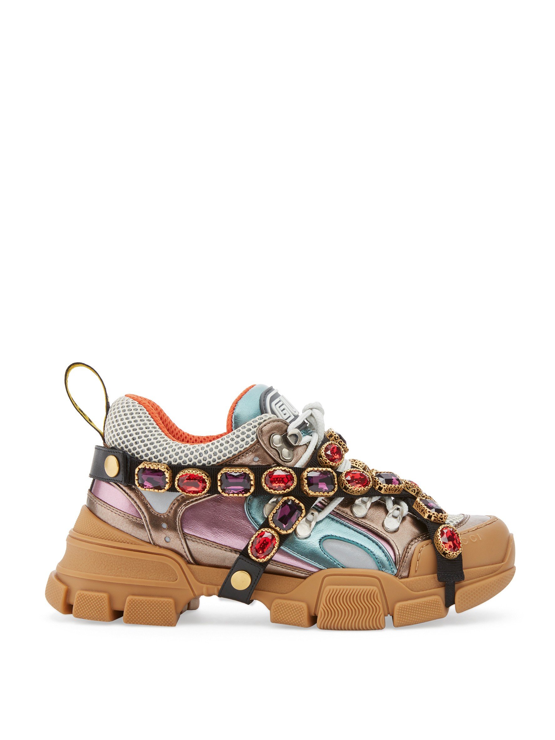 Gucci. Embellished with sparkling crystals on its removable elastic strap, the oversized Flashtrek sneakers from Gucci make a strong fashion statement. The sneakers have a dynamic mix of materials including rubber, suede and technical canvas, HK$12,600