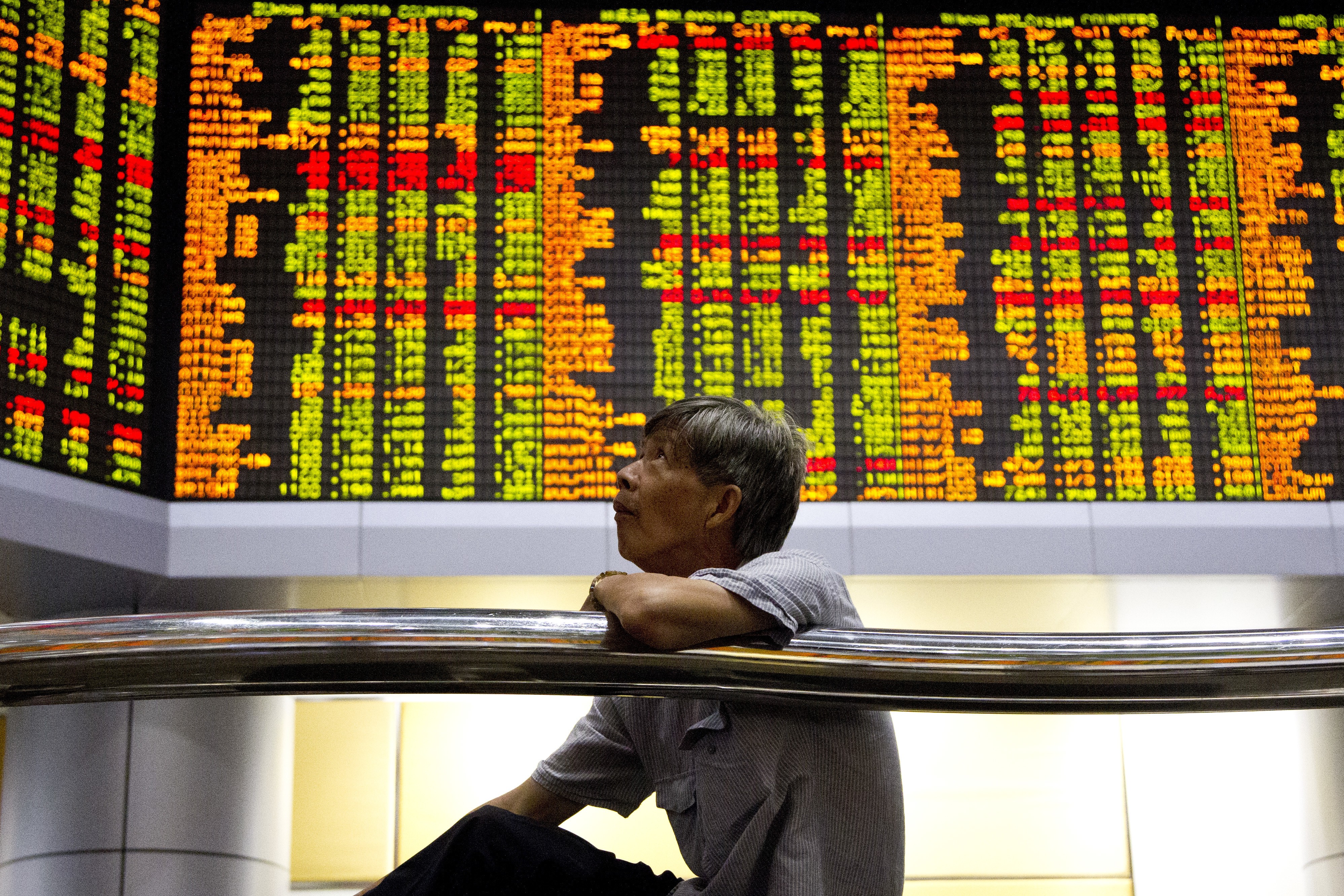 An investor sits in front of trading boards at a private stock market gallery in Kuala Lumpur, Malaysia, on September 13. Photo: AP