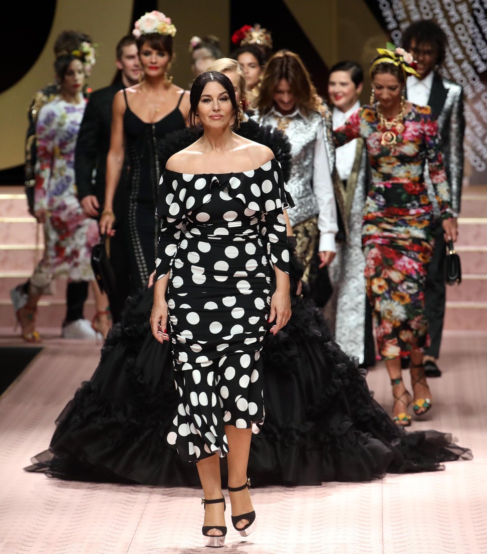 Monica Bellucci wears a black and white off-the-shoulder polka-dot dress with metallic sandals as Dolce & Gabbana present their spring-summer 2019 collection. Photo: EPA-EFE
