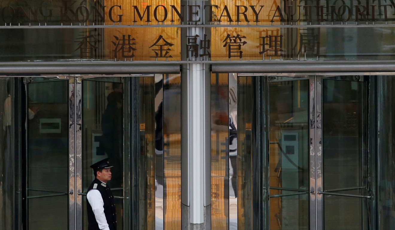 The entrance to the Hong Kong Monetary Authority in Hong Kong. Officials there have raised base lending rate to maintain the differential between the city’s and US interest rates, so keeping the exchange rate between the two dollar currencies steady. Photo: Reuters