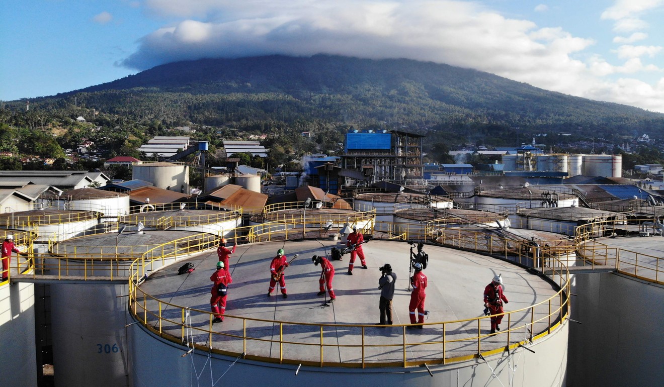 The rock band Boomerang performs on top of a silo at the Wilmar International refinery in Bitung, North Sulawesi in a protest against the palm oil industry. Photo: AFP