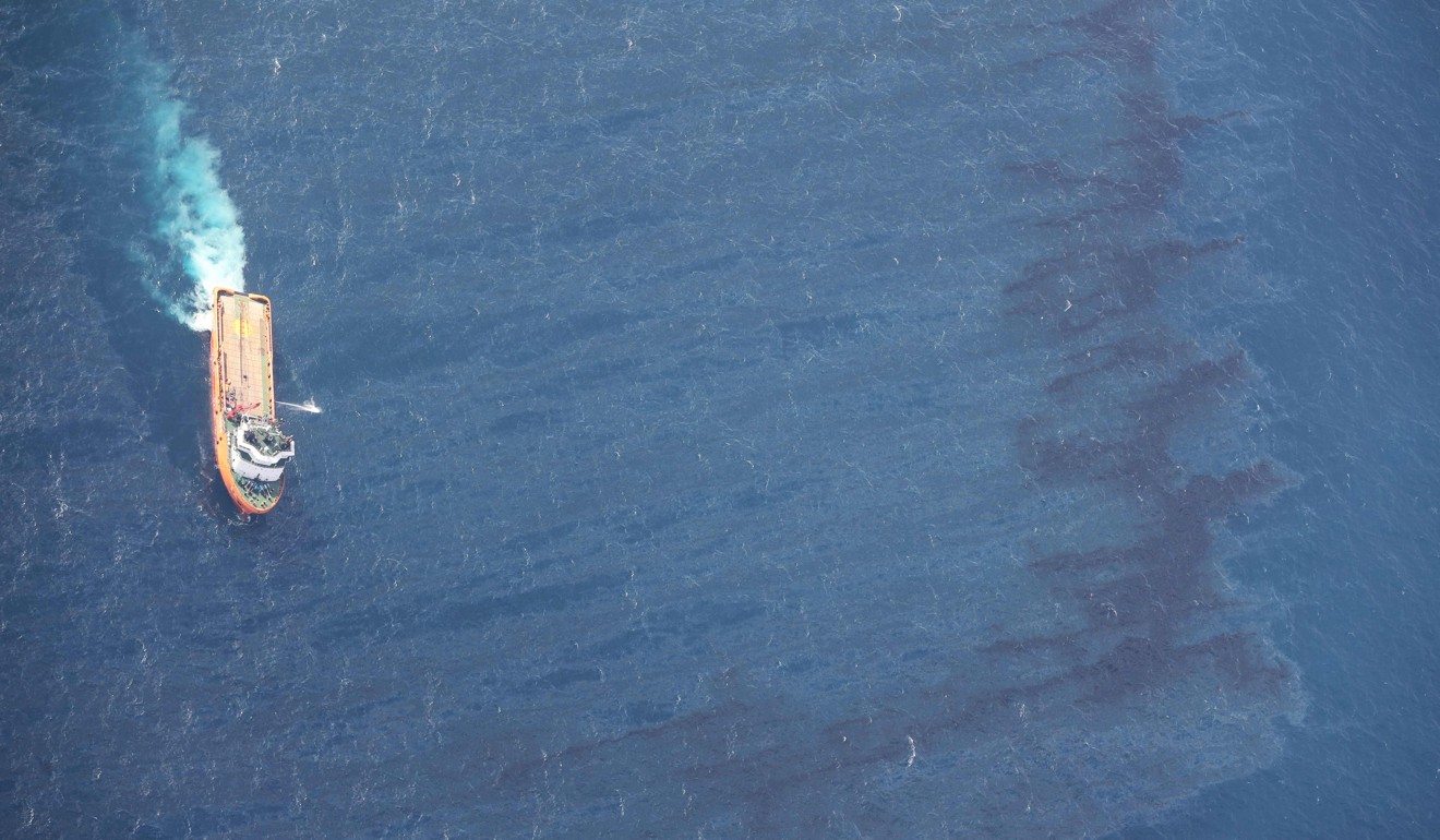 A Chinese ship helps to clear an oil spill after the sinking of an Iranian tanker. Photo: AFP