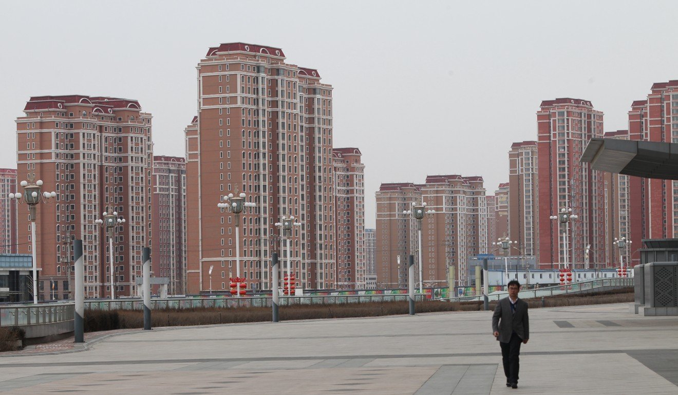 A man walks down a deserted public area flanked by residential buildings in Kangbashi district, Ordos city, Inner Mongolia, on February 16, 2017. The district garnered attention after international media characterised it as a “ghost city” with few actual residents. Photo: Simon Song