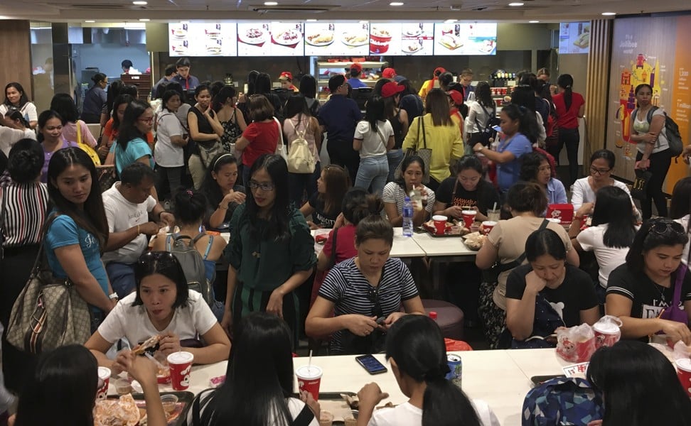 Foreign domestic workers pack the Jollibee outlet in Central on a recent Sunday. Photo: Cheryl Arcibal