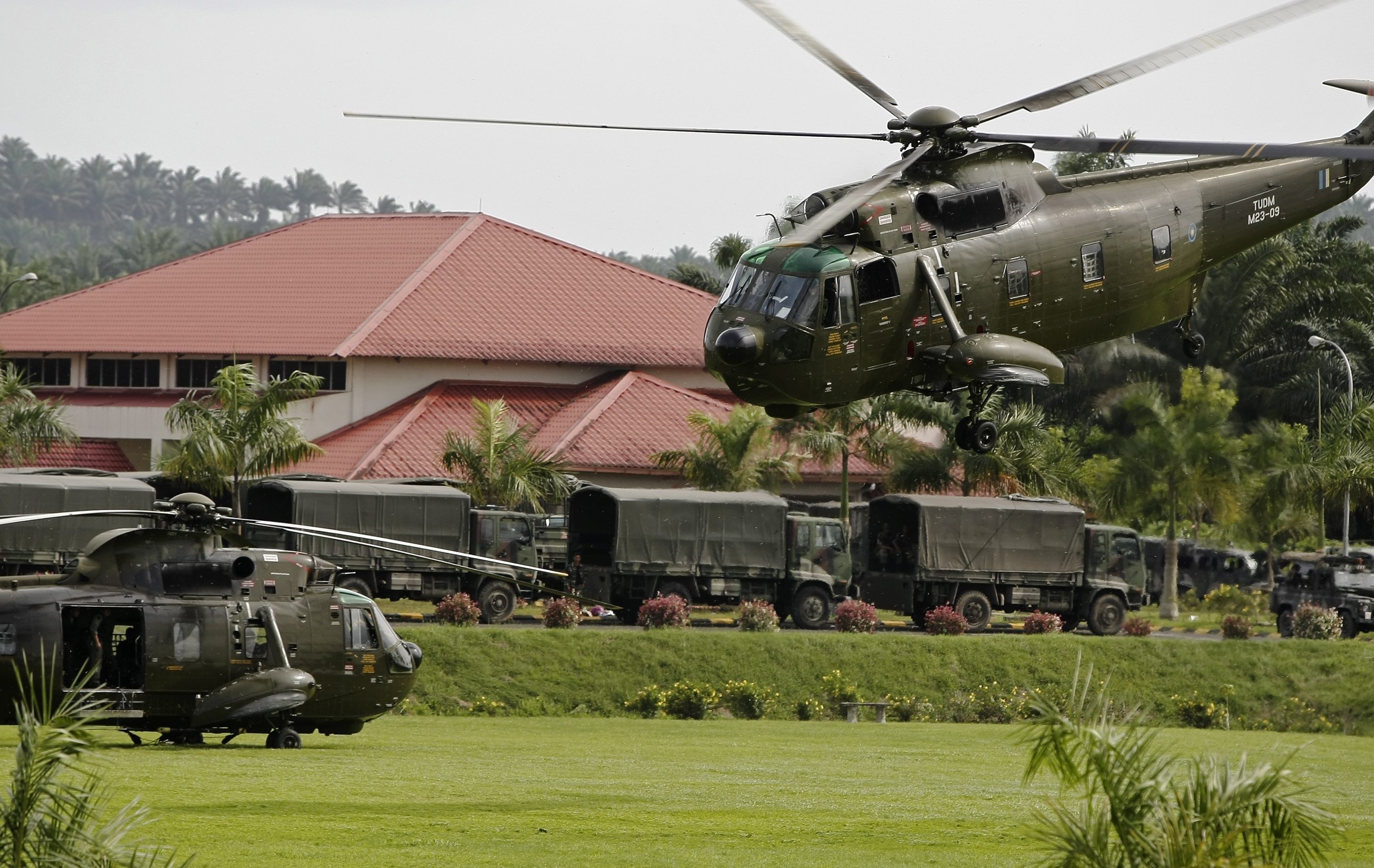 Malaysian army helicopters and vehicles at the temporary army base camp at Felda Sahabat near Lahad Datu. Photo: EPA