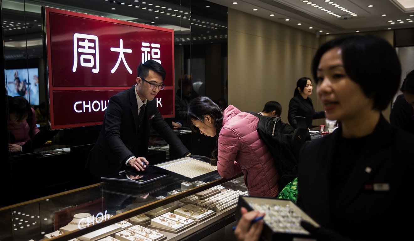 Employees serve customers shopping for jewellery at a Chow Tai Fook Jewellery store in Hong Kong. Photo: Bloomberg