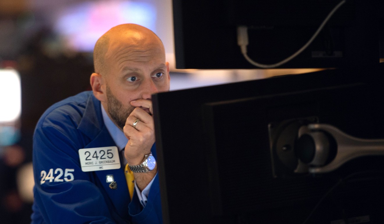 Traders work on the floor of the New York Stock Exchange (NYSE) on Wednesday as shares took a battering. Photo: AFP