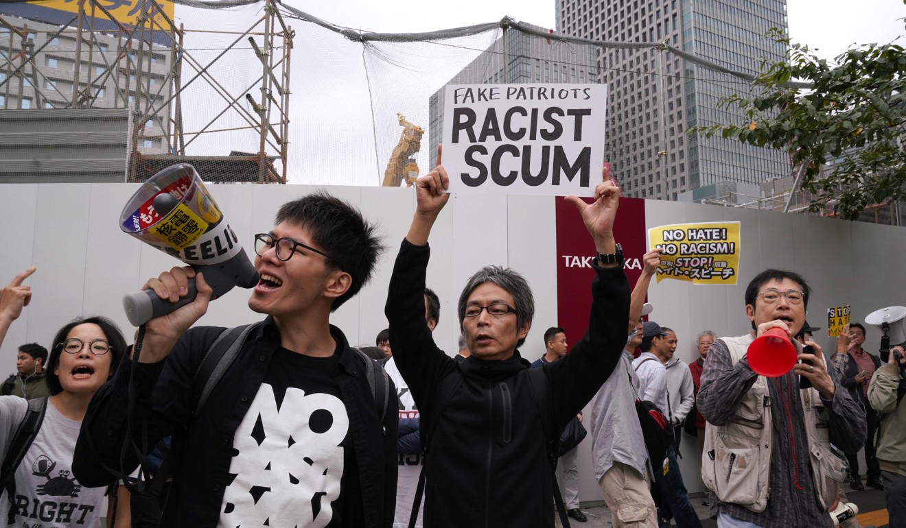 Counter-protesters support admitting more foreign workers. Photo: Bloomberg