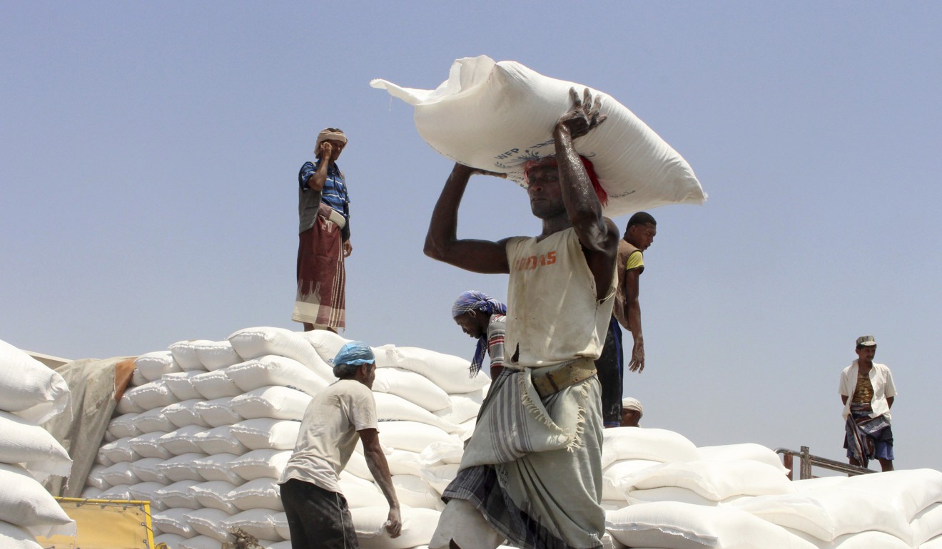 Men deliver UN World Food Programme (WFP) aid in Yemen. Photo: AP