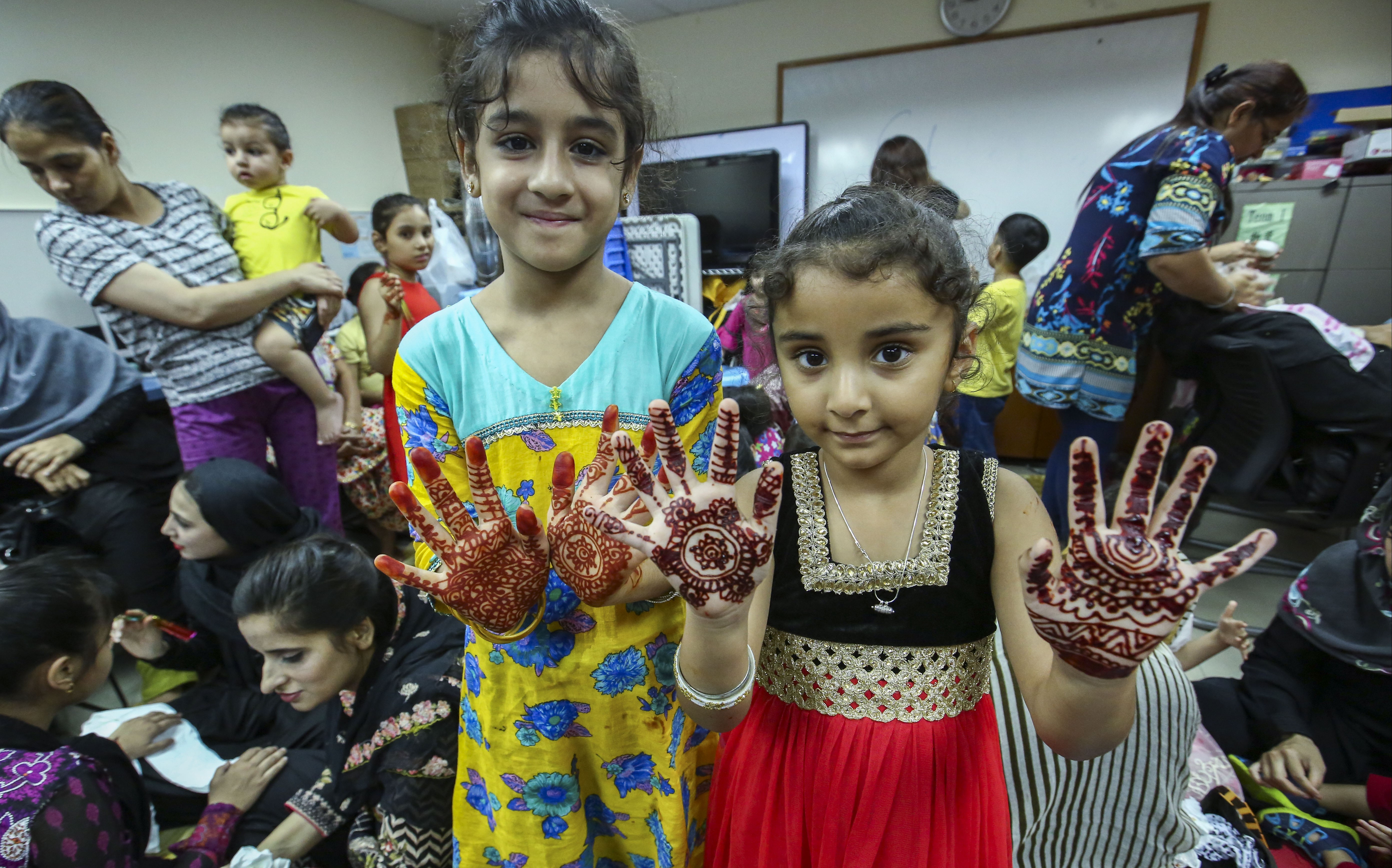 Two Muslim children show off henna art as part of the community’s celebration of the end of Ramadan in June. The Hong Kong government hopes its new measures can bridge the gaps in the current ethnic minority support network. Photo: Edmond So