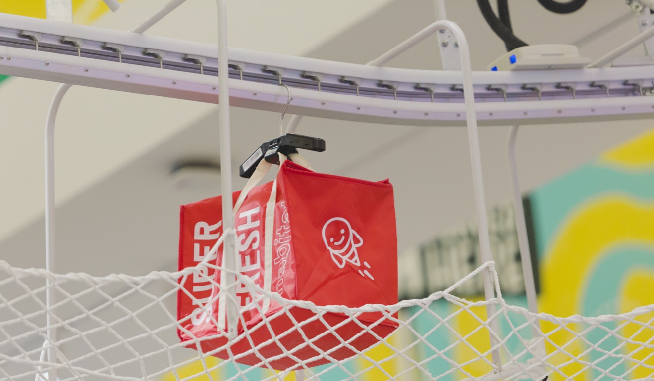 Conveyor belts transport bags of packed groceries across the store in preparation for delivery. Photo: Handout