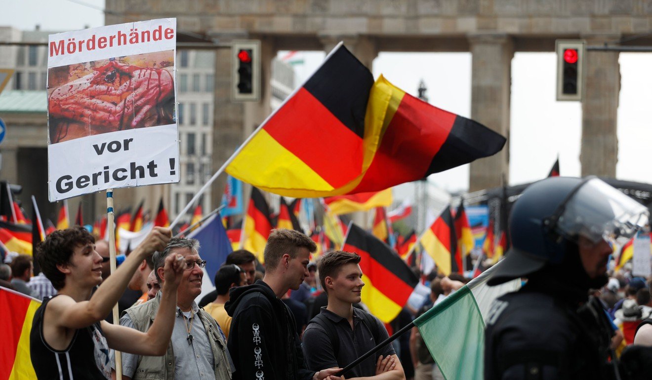 Alternative for Germany supporters wave German flags in front of the Brandenburg Gate in Berlin in May. The AfD, whose platform has emphasised opposition to bailouts of troubled European economies like Greece, as well as immigration and the emphasis on the “national shame” of the second world war, became the most powerful opposition party in the Bundestag in 2017. Photo: AFP