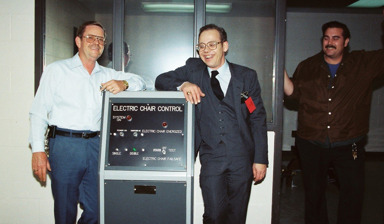 Fred Leuchter, centre, stands near the control panel for the electric chair he built for Tennessee in 1988-9. File photo: AP