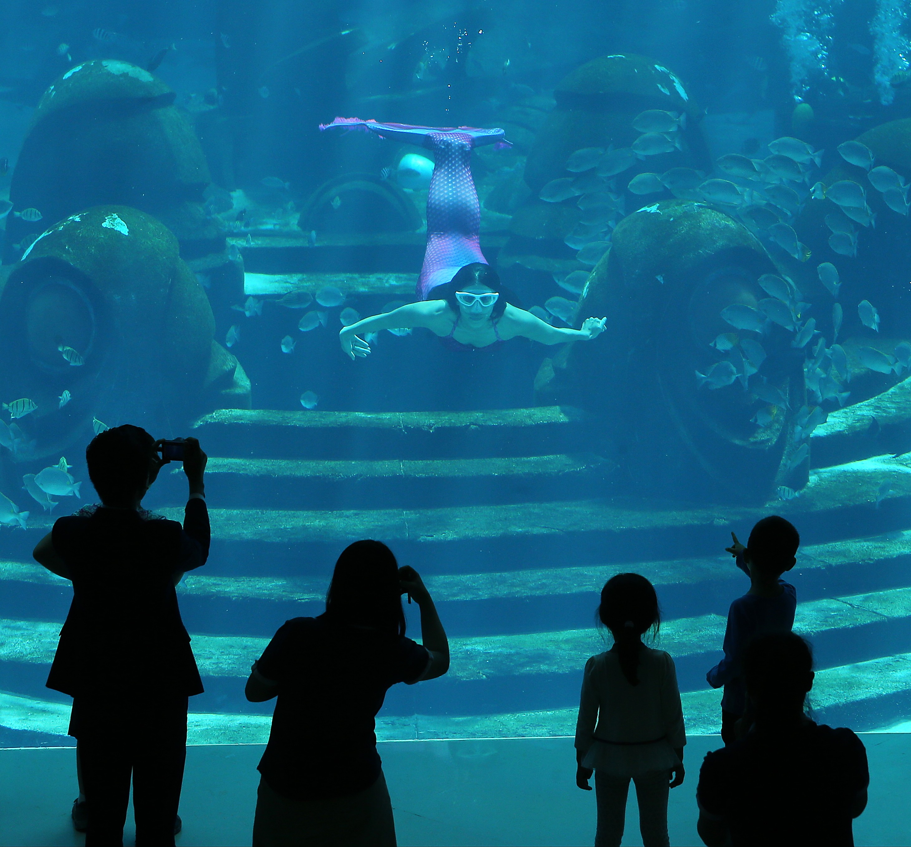Visitors watch the mermaids’ performance inside Atlantis Sanya hotel in Sanya. The island resort in southern China comes out as the top domestic choice for well-healed Chinese to have their holiday home, in the latest Hurun lifestyle survey. Photo: SCMP / Dickson Lee