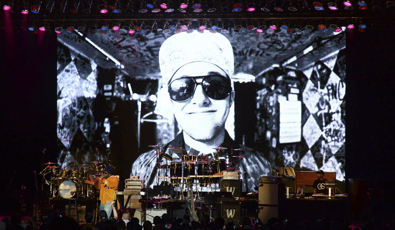 Juicy J performs during the tribute event Mac Miller: A Celebration of Life last Wednesday at the Greek Theatre in Los Angeles. Pictured on screen is the late rapper Mac Miller. Photo: AP