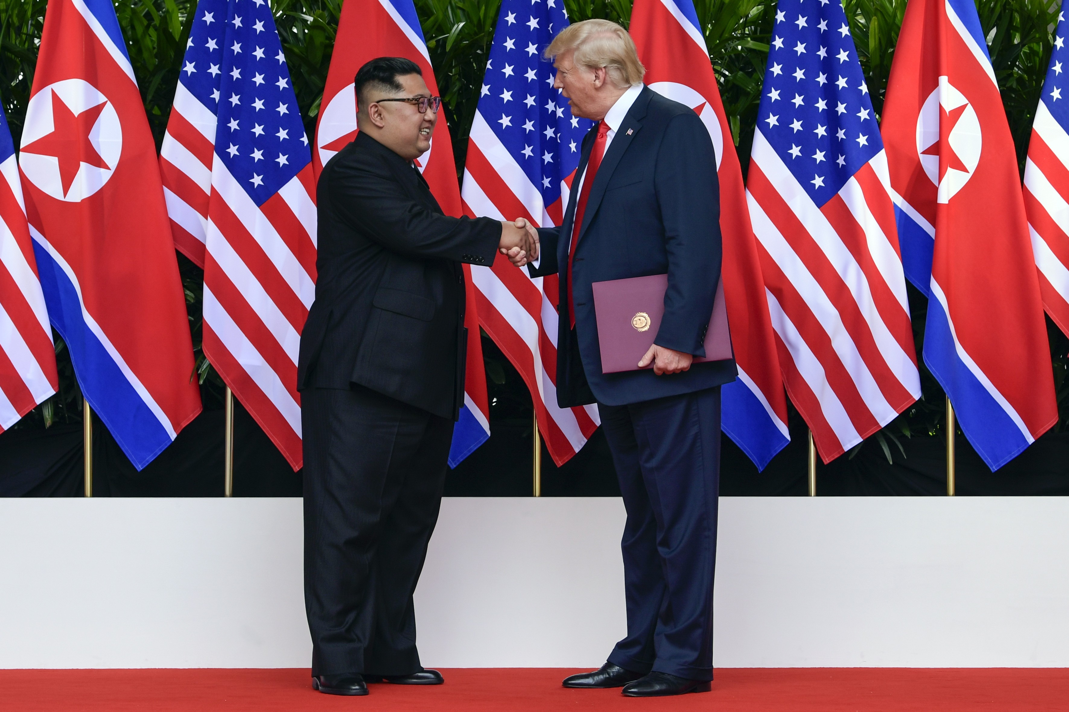 North Korea leader Kim Jong-un (left) and US President Donald Trump shake hands after their meetings on Sentosa Island in Singapore on June 12. Photo: AFP