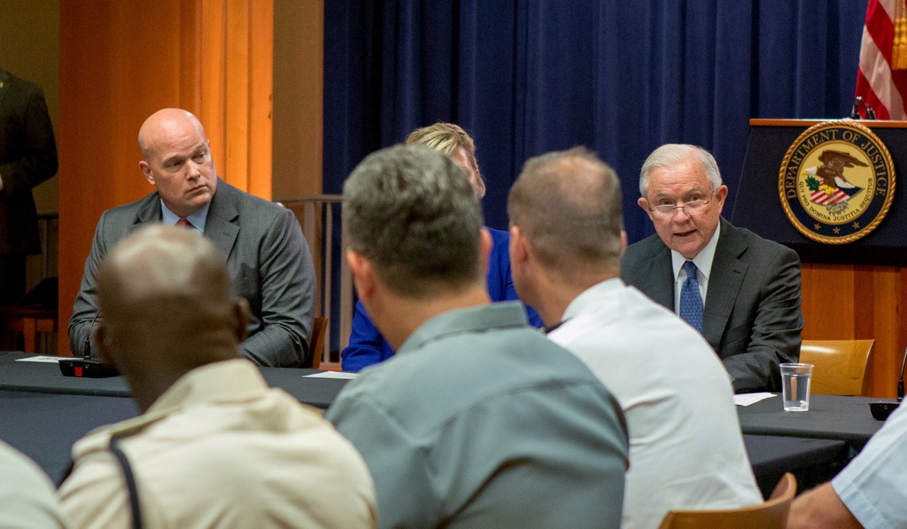 Matthew Whitaker (left) looks over at Jeff Sessions during a roundtable discussion with foreign liaison officers at the Justice Department in Washington. Photo: Reuters