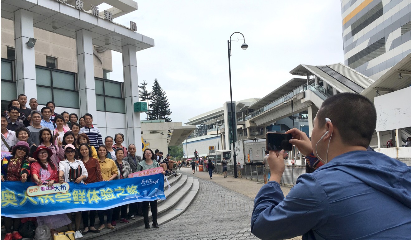 A man took out a banner and took a group photo but said he was not the tour guide. Photo: Kanis Leung