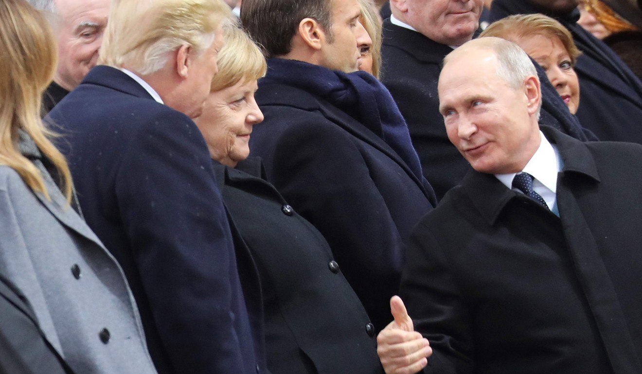 Russian President Vladimir Putin gives US President Donald Trump a thumbs up in Paris. Photo: AFP