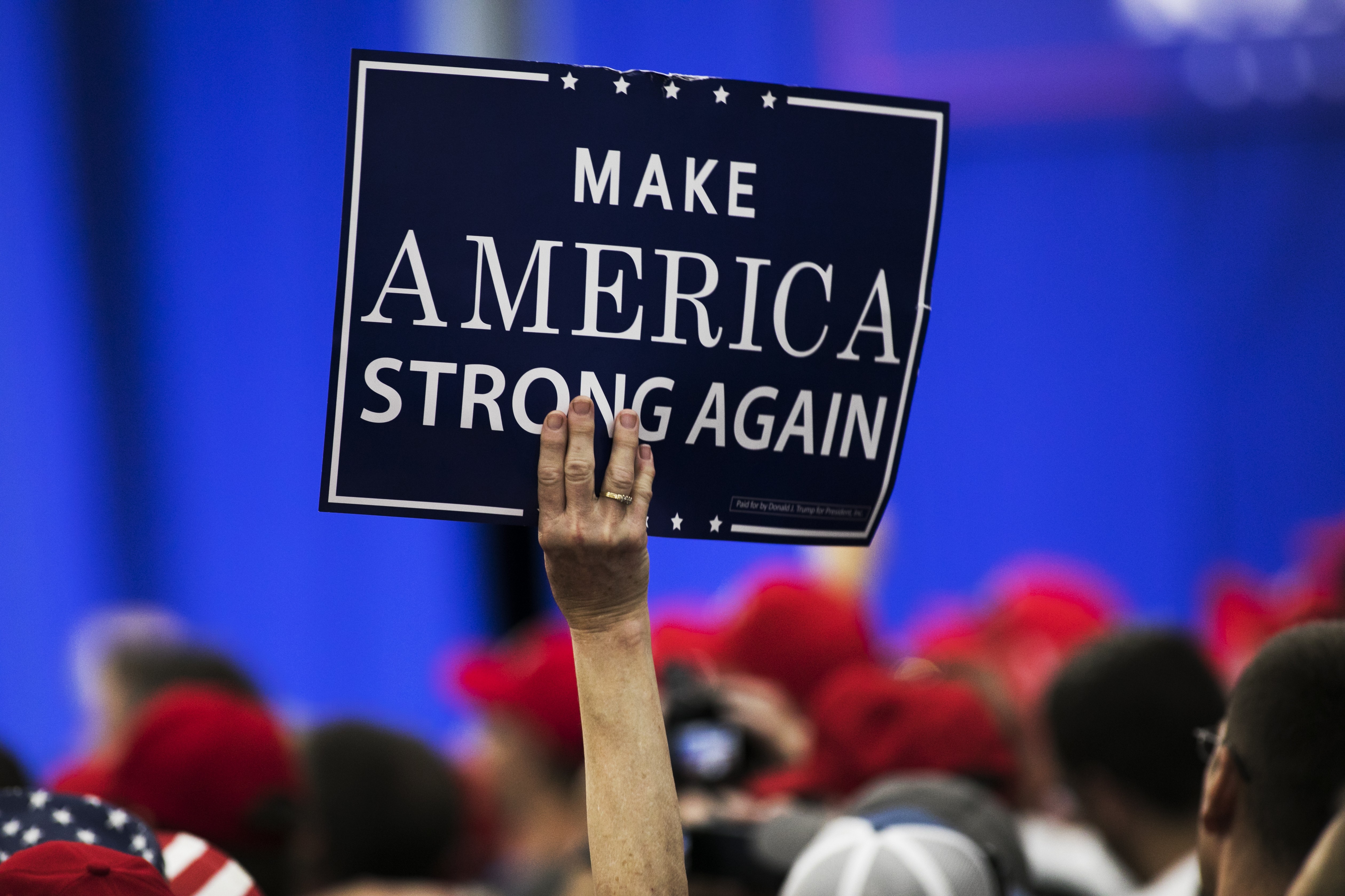 An attendee holds a placard during a rally with US President Donald Trump in Ohio, on August 4, 2018, when Trump defended his use of tariffs that have inflamed tensions with China and Europe, telling an audience of supporters that playing hardball on trade is "my thing". Photo: Bloomberg