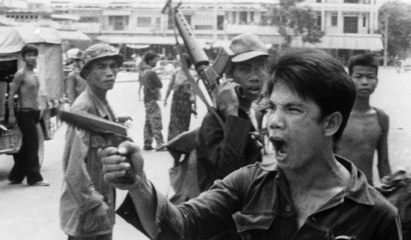 In this file photo from April 17, 1975, a Khmer Rouge soldier waves his pistol and orders store owners to abandon their shops in Phnom Penh, Cambodia on as the capital fell to the communist forces. Photo: AP