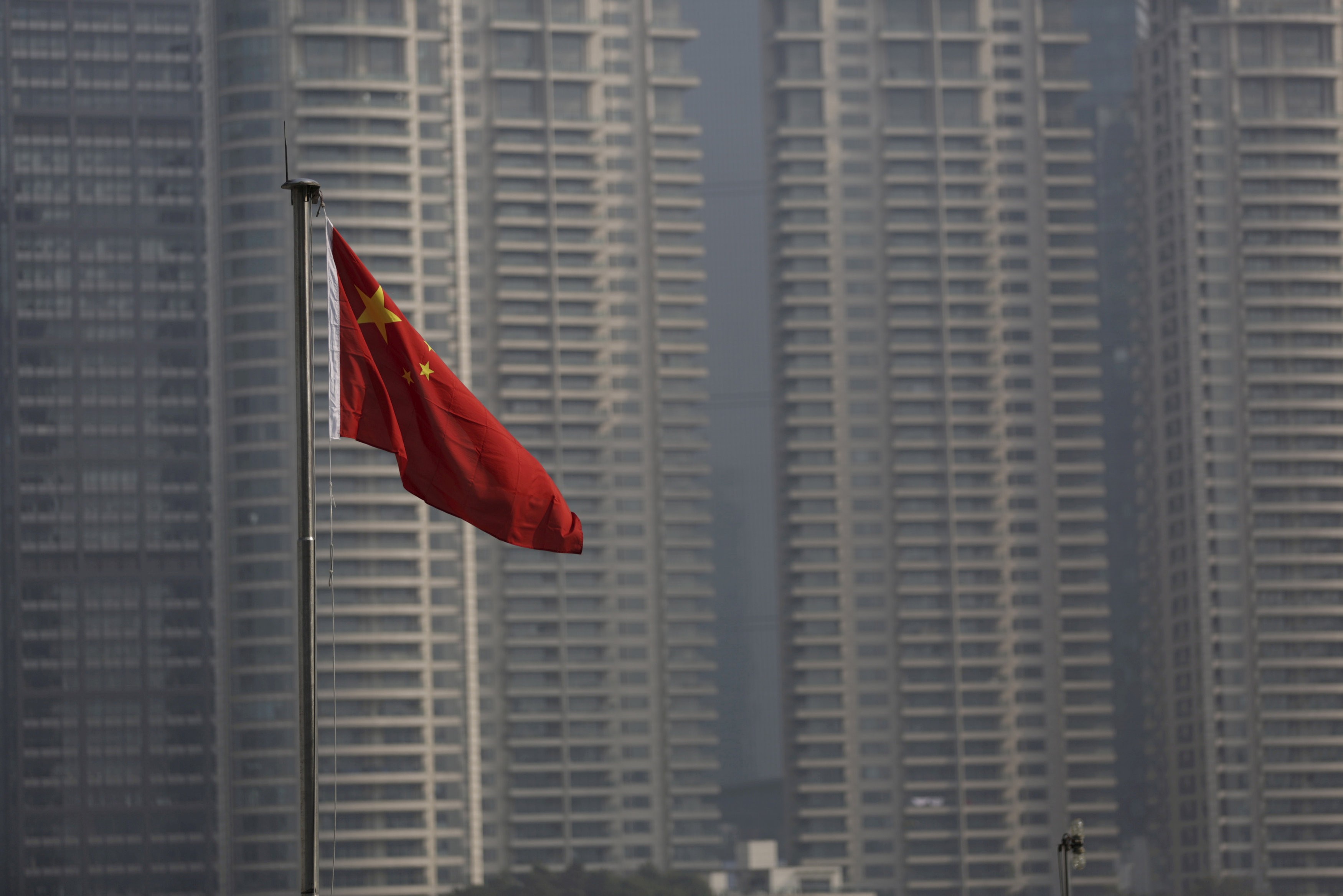 A Chinese flag flies in the financial district of Pudong in Shanghai. By easing restrictions on FDI in China, the government shows it understands that a more level playing field for foreign companies is ultimately beneficial for its own long-term prosperity. Photo: Reuters