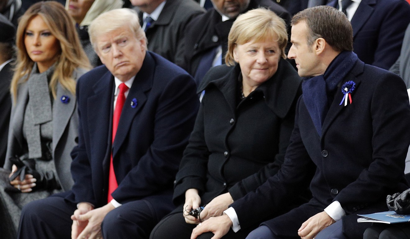 US President Donald Trump watches French President Emmanuel Macron (right) sharing a moment with German Chancellor Angela Merkel during ceremonies to mark the 100th anniversary of the first world war armistice at the Arc de Triomphe in Paris on November 11. Trump could seek to partner with allies in Europe on China’s abuse of intellectual property rights. Photo: EPA-EFE